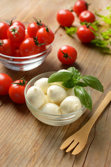 small mozzarella with cherry tomatoes in the glass bowl