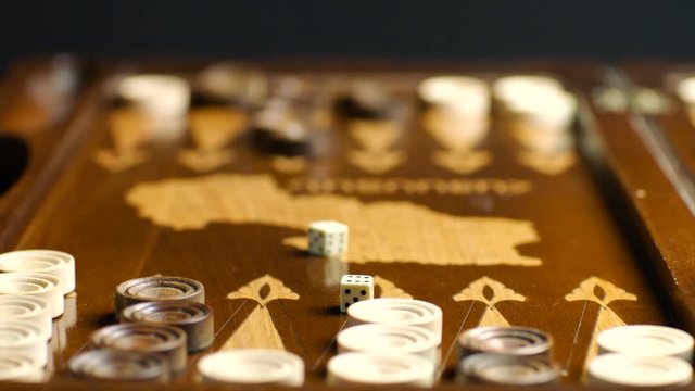 Throwing dices to backgammon board