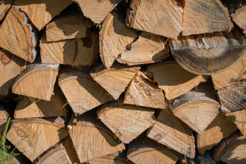 Cut split stacked firewood for winter background close-up