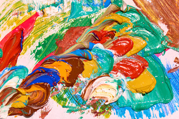 Palette covered by colorful layers of paint close-up abstract texture, backgrond