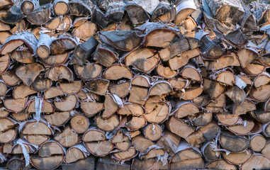 Cut split stacked firewood for winter background close-up