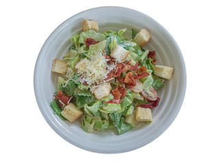 Vegetables,bacon with Caesar salad source on white background.