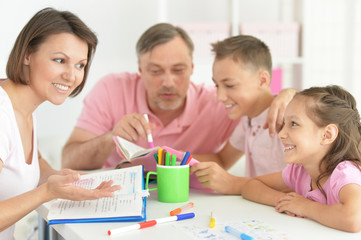 Obraz na płótnie Canvas Big happy family doing homework at home