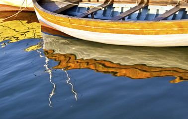 colorful water reflections of a fishing boat - Aegean sea Greece