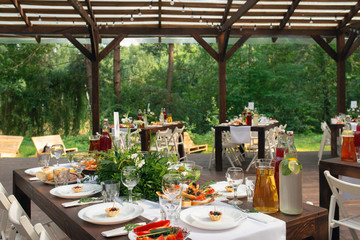 Elegant wedding table arrangement, floral decoration, restaurant. Wedding table setup. Wedding in the forest