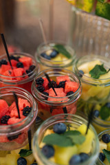 Delicious sweets on candy buffet. Lot of colorful desserts and fruits. Bluberry, watermelon, banana, grape, strawberry