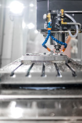 High precision CNC machining center working, operator machining automotive sample part process in factory