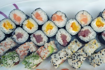 Assorted sushi set served on white plate.