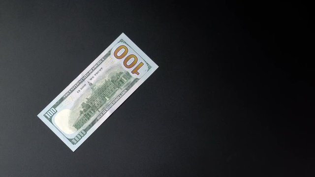 Paper dollar with space for your text or logo on a black background 4k.