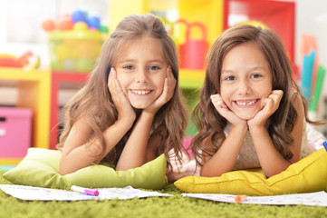Fototapeta na wymiar Portrait of two beautiful little girls studying