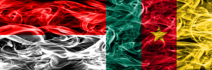 Indonesia vs Cameroon smoke flags placed side by side. Thick colored silky smoke flags of Indonesian and Cameroon