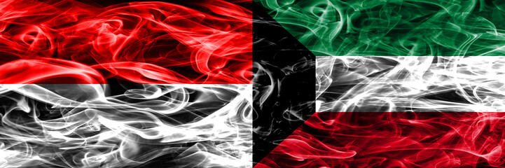 Obraz premium Indonesia vs Kuwait smoke flags placed side by side. Thick colored silky smoke flags of Indonesian and Kuwait
