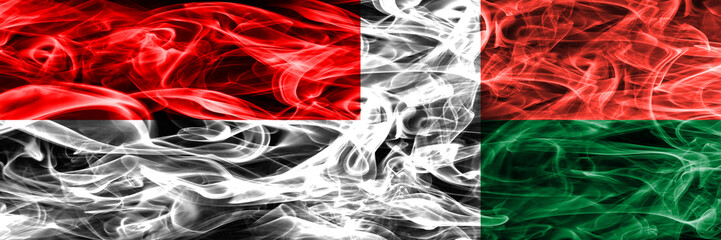 Indonesia vs Madagascar smoke flags placed side by side. Thick colored silky smoke flags of Indonesian and Madagascar