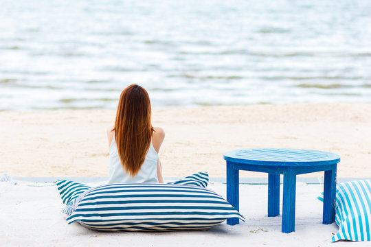 Woman sit on beach.