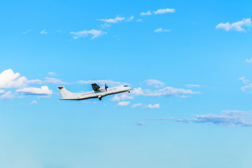 Fototapeta na wymiar Flying airplane on blue sky