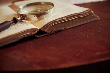 Magnifying glass and old book