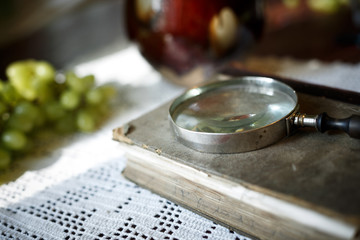 Magnifying glass and old book