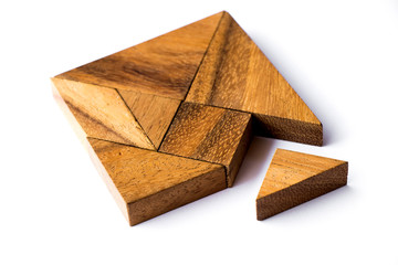 Wood tangram puzzle in square shape that wait triangle piece to fulfill on white background