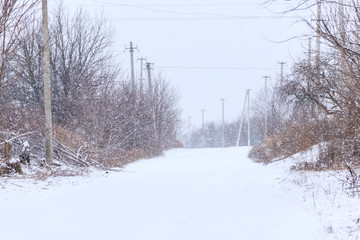 Snowy rural street during snowfall