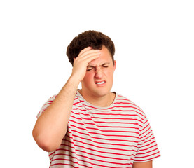 Fototapeta premium Tired unhappy guy holding hand on forehead, standing and suffers headache because of huge pressure at work . emotional man isolated on white background