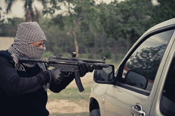 Close up terrorist,Bandits point gun to car,Thailand people,Thieves raided in the desolate