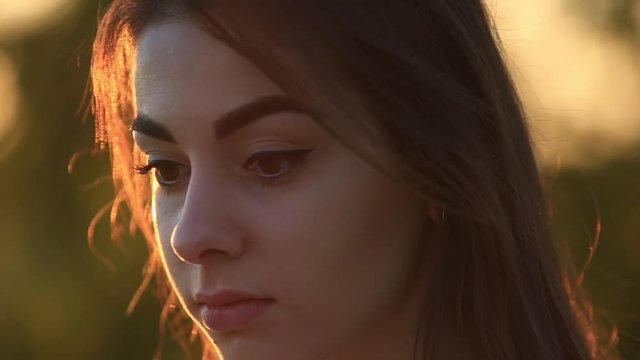 Beautiful lady in sunset. Close-up. 50fps