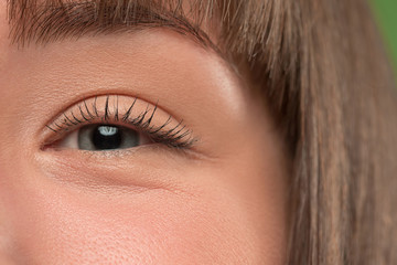 Fototapeta premium The close up gray eye on face of young beautiful caucasian girl
