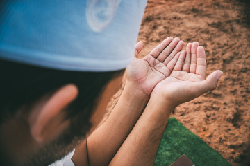 Silhouette Young asian muslim man praying on sunset,Ramadan festival concept