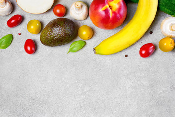 Delicious fresh fruits and vegetables on a concrete stone background. Top view with copy space.
