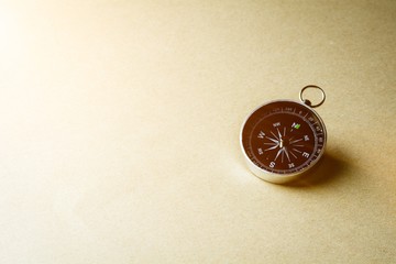 compass on brown paper background.
