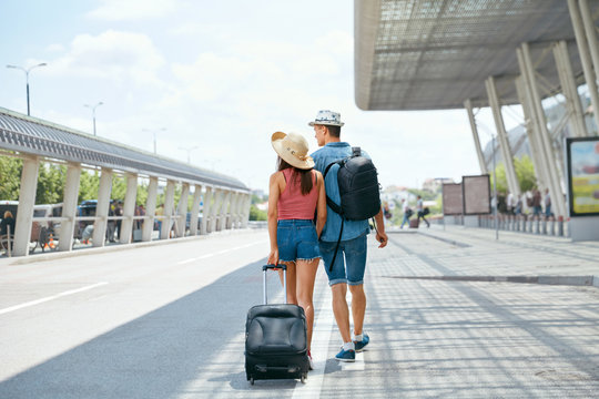 Travel. Couple Near Airport With Suitcase Traveling In Summer