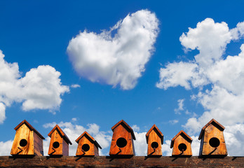 Bird house nesting on blue sky background