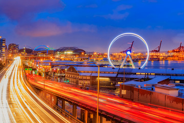 Seattle waterfront at sunset with Great Wheel and trail lights