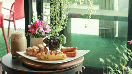 Breakfast table set selective at Croissant Bread and ice coffee ready to serve.