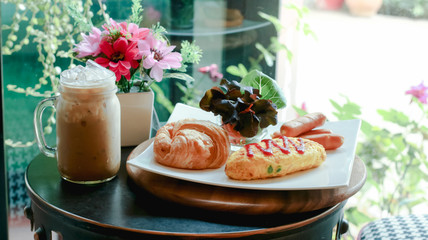Breakfast table set selective at Croissant Bread and ice coffee ready to serve.