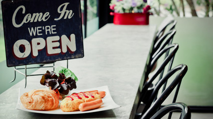 Breakfast table set, Croissant Bread , Omelet , Sausage and ice coffee ready to serve at coffee shop now open.