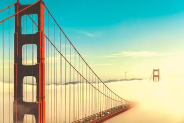 Overlook of the famous landmark the Golden Gate Bridge caught in the mist, San Francisco, California pacific coast, USA. Vintage look.