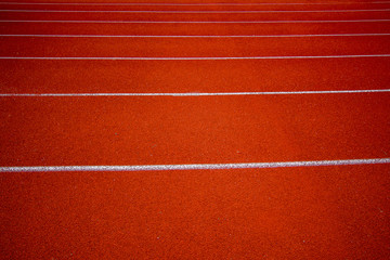 Red running track in the stadium.white line and Green lawn