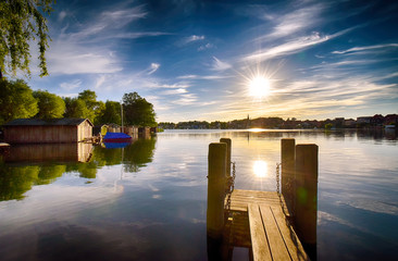 Sunset on the lake with jetty in Malchow (Mecklenburg-Vorpommern / Germany)