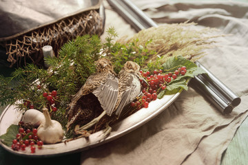 Wild hunting fowls in cooking. Two snipe or woodcock lie on metal dish. Hunting composition,...