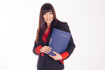 beautiful woman with dark hair and dark eyes holding folder with bewerbung signed on it  isolated