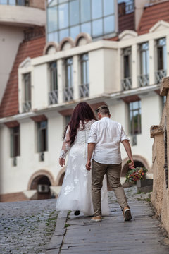 Attractive Plus Size Bride In White Dress On Walk With Groome