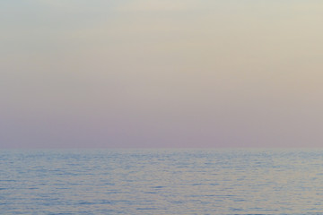The sea at sunset, the sky in pastel colors.