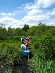 canoe portage across grassy field