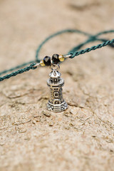 Tiny fashionable jewelry in the shape of lighthouse