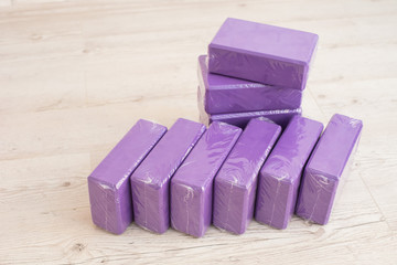A stack of blocks for yoga lilac. Several bricks for pilates of violet color