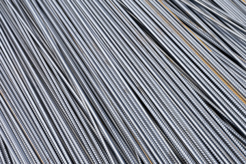 Stack of heavy metal reinforcement bars with periodic profile texture. Close up steel construction armature. Abstract industrial background concept. Copy space.