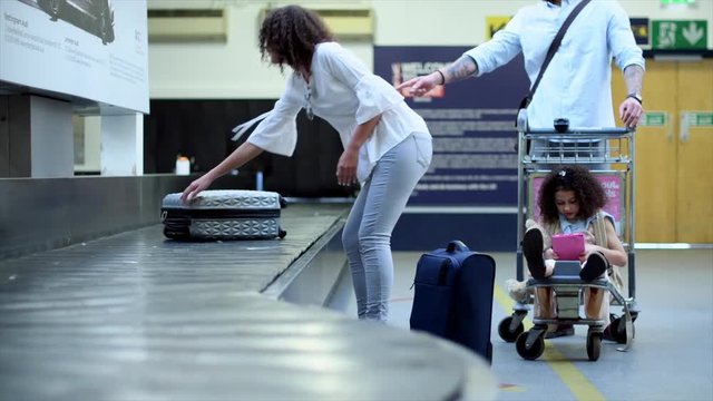 Woman picking up luggage