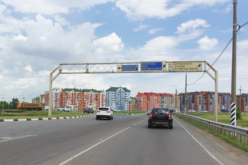 Circular traffic at the intersection with the highway near West bypass and road signs with...