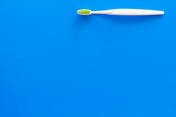 Clean teeth. Toothbrushes on blue background top view copy space